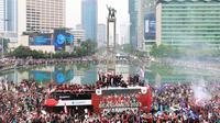 Sejumlah suporter melakukan perayaan bersama pemain Timnas Indonesia U-22 saat mengikuti parade perayaan kesuksesan Timnas Indonesia U-22 di SEA Games 2023 Kamboja di Bundaran Hotel Indonesia, Jakarta, Jumat (19/05/2023). (Bola.com/M Iqbal Ichsan)