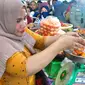 Seorang pengecer menimbang tomat yang dibeli warga pada pasar murah yang digelar Pemprov Gorontalo di Pasar Sentral Kota Gorontalo. Foto :Haris Diskominfotik (Arfandi Ibrahim/Liputan6.com)