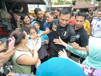  Sejumlah warga berebut untuk bersalaman dengan Cagub DKI Jakarta, Agus Harimurti Yudhoyono, Jakarta, Senin (28/11). Agus Harimurti Yudhoyono temui warga dan pedagang di Pasar Sumur Batu. (Liputan6.com/Yoppy Renato)