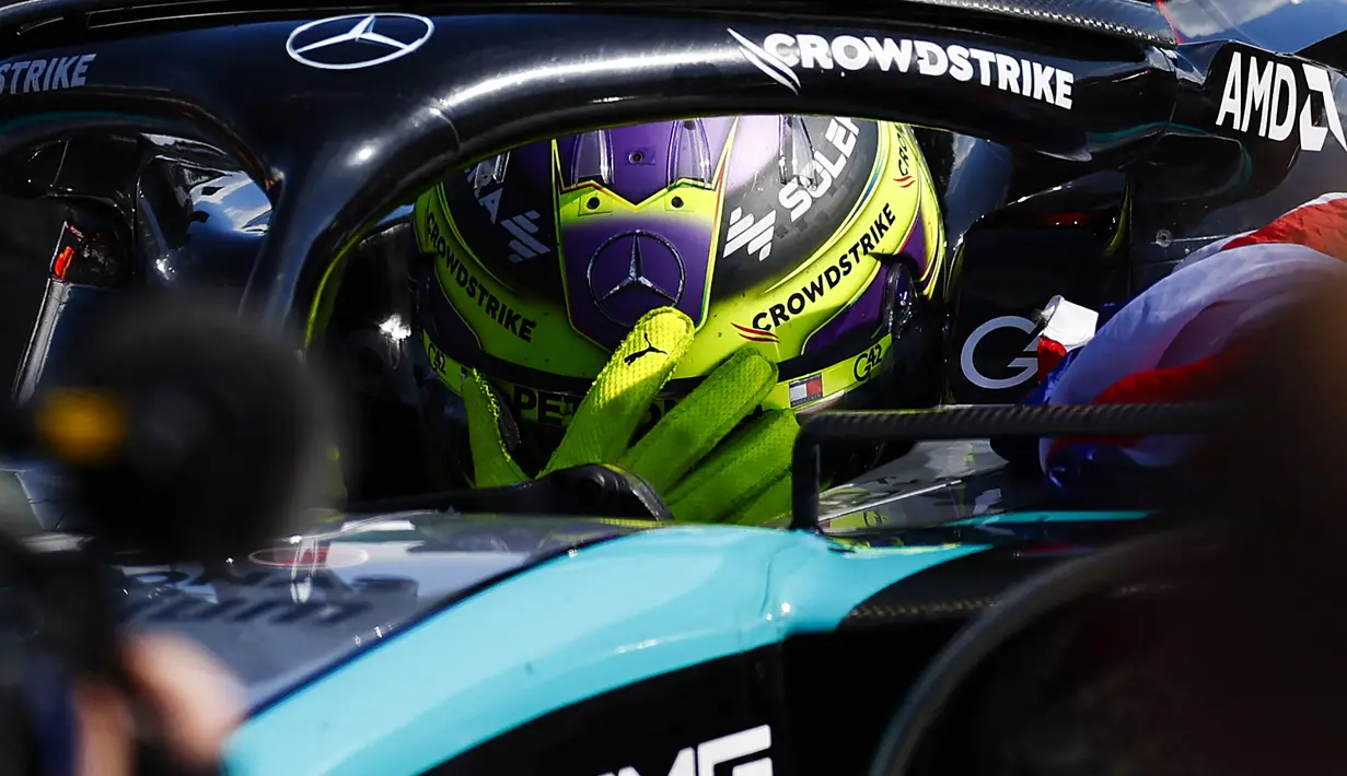 Ekspresi haru pembalap Mercedes, Lewis Hamilton saat memenangkan Formula 1 GP Inggris 2024 yang berlangsung di Sirkuit Silverstone, Inggris, Minggu (08/07/2024). (AFP/Benjamin Cremel)