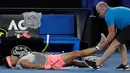 Petenis Spanyol, Rafael Nadal mendapat perawatan dari pelatihnya terkait cedera paha kanan pada perempat final Australia Terbuka 2018 di Melbourne, Selasa (23/1). Nadal mundur di set kelima saat menghadapi petenis Kroasia, Marin Cilic. (AP/Dita Alangkara)
