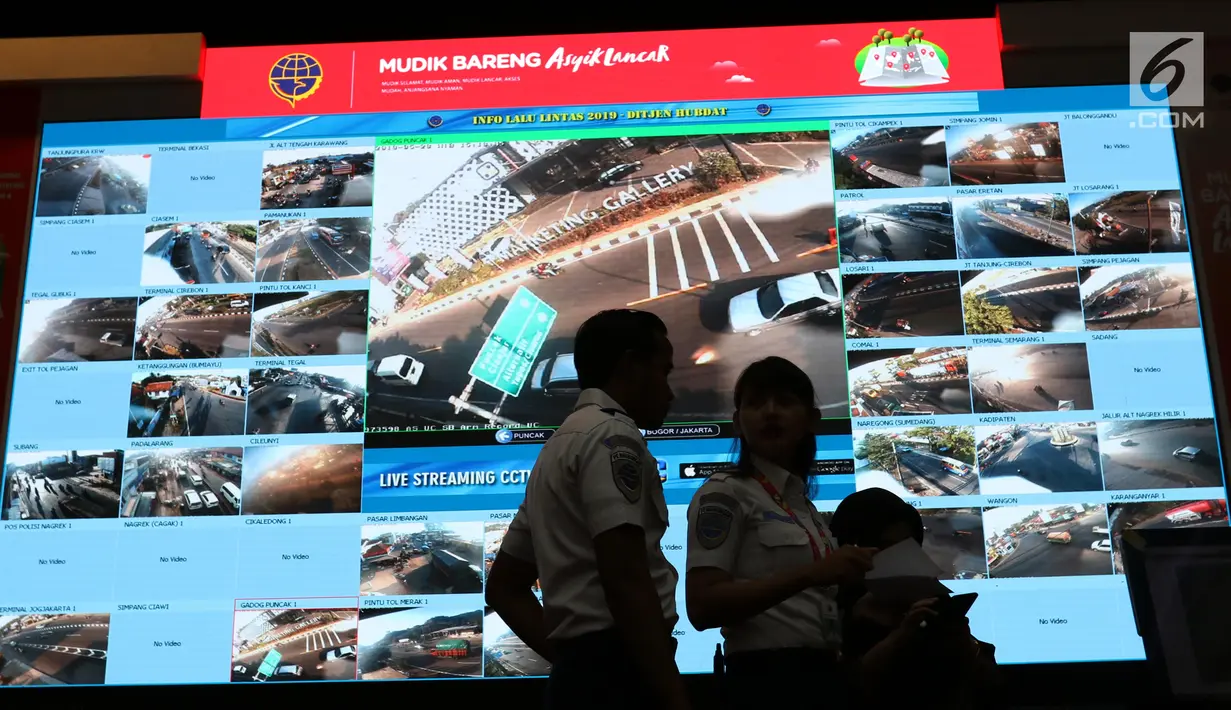 Petugas melintasi layar pantau CCTV jalur mudik di Posko Tingkat Nasional Angkutan Lebaran Terpadu 2019, Kantor Kemenhub, Jakarta, Selasa (28/5/2019). Posko tersebut diselenggarakan untuk memudahkan koordinasi antarinstansi dalam memantau arus mudik dan arus balik. (Liputan6.com/Angga Yuniar)