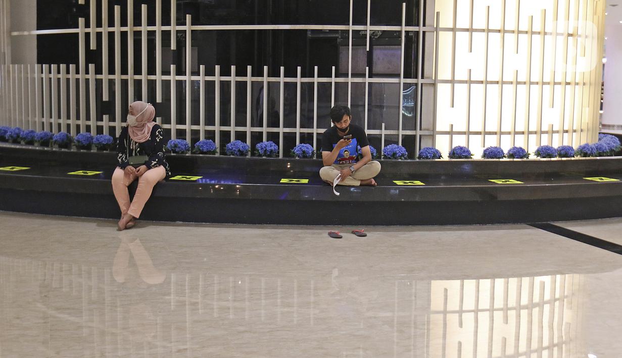 Pengunjung duduk dengan menjaga jarak di Mall Senayan City, Jakarta, Senin (15/6/2020). Pusat perbelanjaan atau mal di Jakarta kembali dibuka pada Senin (15/6) di masa PSBB transisi dengan jumlah pengunjung masih dibatasi hanya 50 persen dari kapasitas normal. (Liputan6.com/Herman Zakharia)