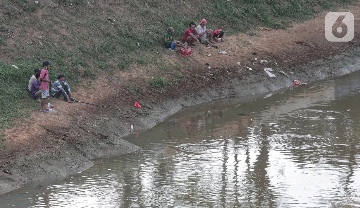 Warga melakukan aktivitas mancing di Kanal Banjir Barat, Jakarta, Selasa (9/6/2020). Fase pertama PSBB transisi di Ibukota dimanfaatkan warga untuk memancing. (Liputan6.com/Johan Tallo)