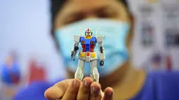 Seorang pelanggan menunjukkan sebuah model robot mainan Gundam di mal Siam Paragon di Bangkok, Thailand (24/9/2020). Pameran tersebut dibuka pada Kamis (24/9) di mal Siam Paragon dan akan berlangsung hingga 4 Oktober mendatang. (Xinhua/Rachen Sageamsak)