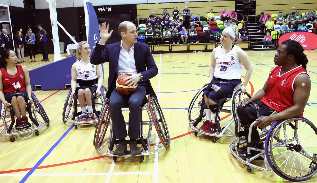 Pangeran William menemui pemain basket kursi roda dalam kunjungannya ke Copperbox Arena, London, Kamis (22/3). Dalam kesempatan tersebut, Pangeran William didampingi sang istri, Duchess of Cambridge Kate Middleton. (Chris Jackson/Pool via AP)