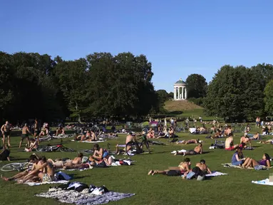 Orang-orang menikmati cuaca musim panas di Taman Englischer Garten, Munich, Jerman, 3 Agustus 2022. (AP Photo/Matthias Schrader)
