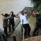 Menteri Pendidikan dan Kebudayaan, Anies Baswedan berusaha sampai ke daratan usai menyeberangi sungai dengan perahu karet, Lebak, Banten, Senin (16/3/2015). Menteri Anies meninjau jembatan yang roboh di Lebak(Liputan6.com/Herman Zakharia)