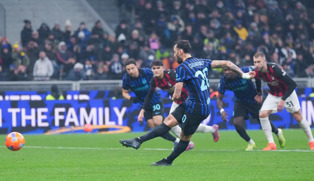 Pemain Inter Milan, Hakan Calhanoglu, melepaskan tendangan penalti saat melawan AC Milan pada laga Italia di Stadion Giuseppe Meazza, Senin (2411/2025). (AP Photo/Antonio Calanni)