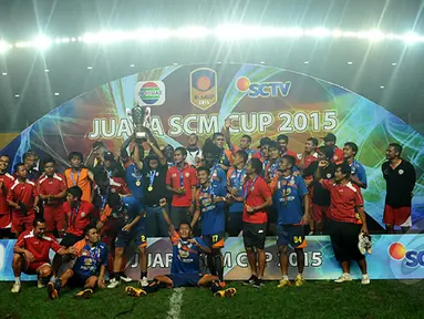 Pelatih Arema Cronus, Suharno (tengah) mengangkat tropi SCM Cup 2015 di Stadion Jakabaring,Selasa (27/1/2015). Arema Cronus unggul 1-0 atas Sriwijaya FC. (Liputan6.com/Johan Tallo)