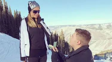 Aktor Chris Zylka berlutut menunjukkan cincin saat melamar pacarnya Paris Hilton di Pegunungan Aspen, Colorado, Amerika Serikat. Paris Hilton bertemu dengan Chris Zylka sejak enam tahun silam, tapi baru mulai menjalin cinta 2016. (Instagram/@parishilton)