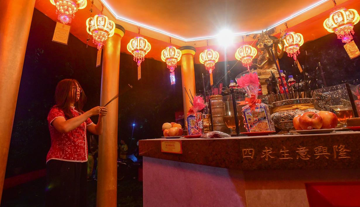 Area vihara dihiasi dengan ratusan lampion merah dan dekorasi khas untuk menciptakan suasana ibadah yang nyaman dan khusyuk. Tampak dalam foto, umat Khonghucu melakukan sembahyang pada malam Tahun Baru Imlek di Wihara Kwan In Thang, Pondok Cabe, Tangerang Selatan, Senin (16/2/2026). (merdeka.com/Arie Basuki)