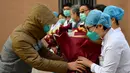 Pasien yang dinyatakan sembuh dari virus corona memberi salam perpisahan kepada petugas medis di Rumah Sakit Afiliasi Pertama Universitas Zhengzhou, Provinsi Henan, China, Selasa (4/2/2020). Ini adalah pasien pertama yang dinyatakan sembuh dari virus corona di Shaanxi. (Xinhua/Liu Xiao)