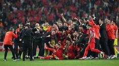 Sejumlah pemain, pelatih, dan ofisial Timnas Turki melakukan selebrasi setelah menang 4-0 atas Latvia pada laga Grup D Kualifikasi Euro 2024 di Konya Buyuksehir Belediye Stadium, Konya, Turki, Senin (16/10/2023) dini hari WIB. Kemenangan ini membuat Turki lolos ke putaran final Euro 2024. (AFP/Ozan Kose)