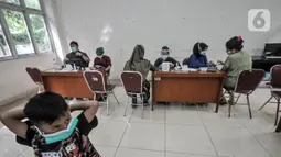 Suasana pelaksanaan vaksinasi COVID-19 di Kantor Kelurahan Ancol, Jakarta, Kamis (17/6/2021). Pembagikan sembako gratis kepada peserta vaksinasi COVID-19 dilakukan LMK Kelurahan Ancol sebagai upaya mendorong minat warga. (merdeka.com/Iqbal S. Nugroho)