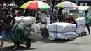 Sejumlah porter mengangkut barang di kawasan Pasar Tanah Abang, Jakarta, Senin (27/3/2023). (Liputan6.com/Johan Tallo)