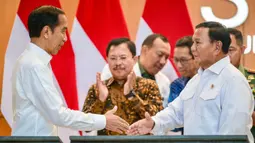 Presiden Republik Indonesia, Joko Widodo (kiri) berjabat tangan dengan Menteri Pertahanan Prabowo Subianto saat peresmian Rumah Sakit Pusat Pertahanan Nasional (RSPPN) di Jakarta pada Senin (19/2/2024). (BAY ISMOYO/AFP)