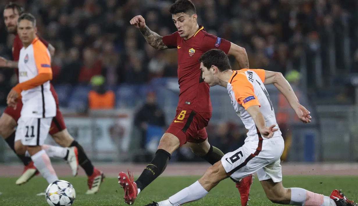 Pemain Roma, Diego Perotti menghalau bola sepakan pemain Shakhtar, Taras Stepanenko (kanan) pada leg kedua 16 besar Liga Champions di Rome Olympic stadium, (13/3/2018). AS Roma Menang 1-0. (AP/Gregorio Borgia)