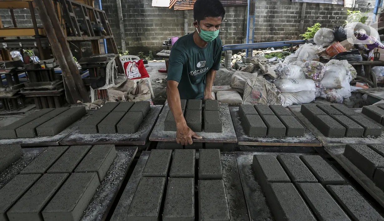 Pekerja menyelesaikan pembuatan paving block berbahan sampah plastik di Rebricks, Pondok Pinang, Jakarta, Kamis (29/10/2020). Rebricks menyasar sampah plastik sebagai salah satu material utama pembuatan paving block dengan harga jual Rp 95.000 per meter persegi. (Liputan6.com/Johan Tallo)