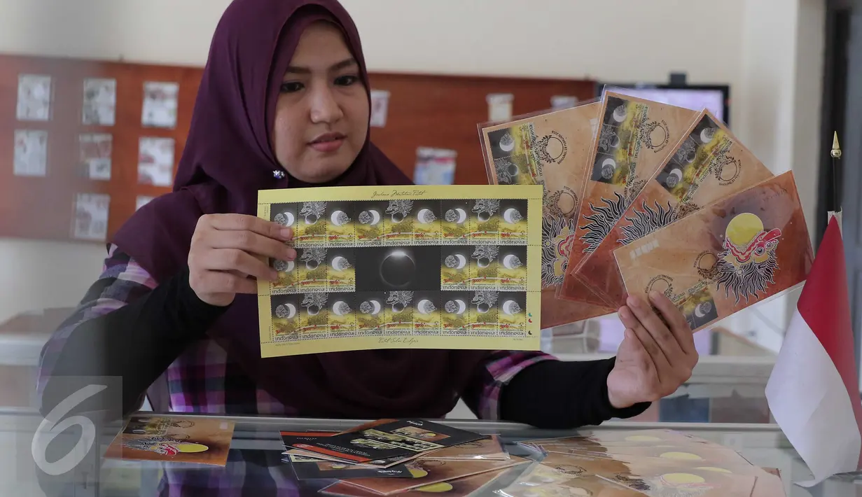 Petugas menunjukan perangko edisi Gerhana Matahari Total di Kantor Pos Indonesia, Jakarta, (25/2). Perangko ini dijual Rp 3 ribu hingga Rp 72 ribu fullset. (Liputan6.com/Angga Yuniar)