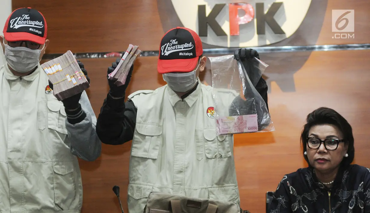 Wakil Ketua KPK Basaria Panjaitan (kanan) mendampingi petugas KPK menunjukkan uang hasil operasi tangkap tangan (OTT) Kabupaten Bengkayang di Gedung KPK, Jakarta, Rabu (4/9/2019). KPK menetapkan tujuh tersangka terkait dugaan suap proyek di lingkungan Kabupaten Bengkayang. (Merdeka.com/Dwi Narwoko)