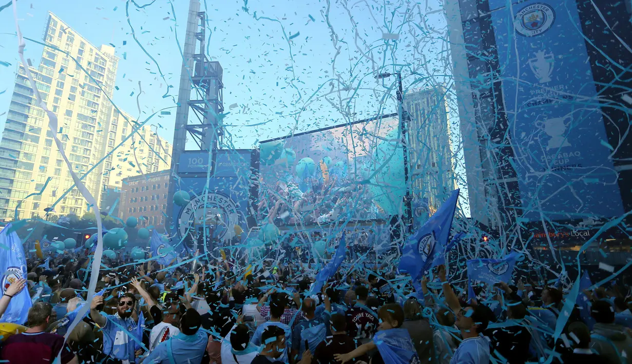 Ribuan suporter merayakan keberhasilan Manchester City menjadi juara Liga Primer Inggris di Manchester, Senin (14/5). Manchester City menggelar parade juara usai mencatatkan gelar ganda di musim 2017/2018. (Richard Sellers/PA via AP)