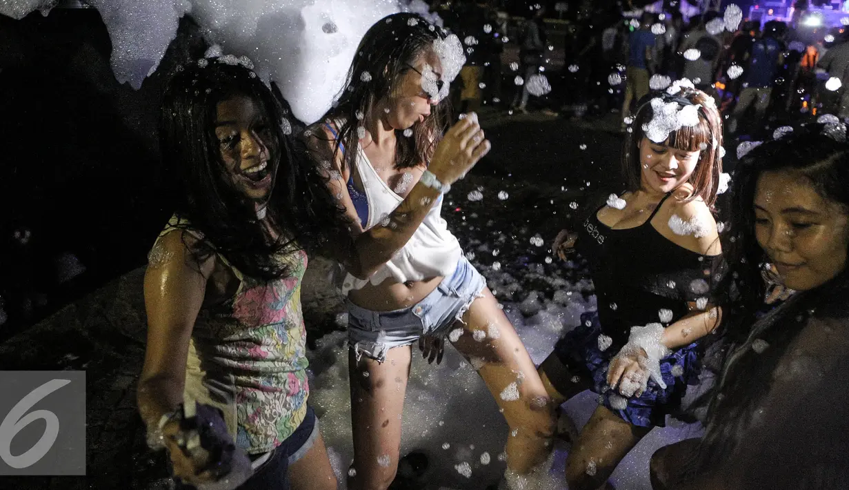 Para wanita menari sambil menikmati alunan musik yang di mainkan DJ saat acara Foam Party di Pantai Festival Ancol, Jakarta, Minggu (2/8/2015). Event musik dengan nuansa busa tersebut diramaikan dengan aksi para DJ ternama. Liputan6.com/Faizal Fanani)
