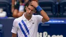 Novak Djokovic Didiskualifikasi dari AS Terbuka 2020: Reaksi petenis Serbia, Novak Djokovic setelah tidak sengaja memukulkan bola ke hakim garis saat kehilangan poin dari Pablo Carreno Busta (Spanyol) pada putaran keempat US Open 2020, di Flushing Meadows, Minggu (6/9/2020). (AP Photo/Seth Wenig)