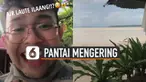 Aneh tapi nyata seorang pria merekam momen berjalan di tengah pantai yang mengering.
