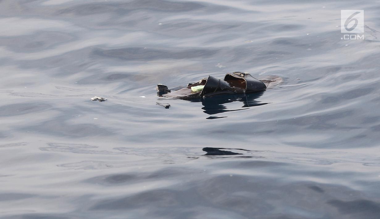 Sandal mengambang di laut pascajatuhnya pesawat Lion Air JT 610 di laut utara Tanjung Pakis, Jawa Barat, Senin (29/10). Pesawat Lion Air JT 610  yang jatuh di Karawang buatan tahun 2018. (Liputan6.com/Herman Zakharia)