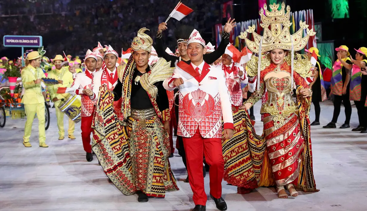 Kontingen atlet Indonesia saat mengikuti parade upacara pembukaan Olimpiade 2016 di Stadion Maracana, Rio de Janeiro, Brasil (5/8). Kostum kontingen Indonesia yang memadukan budaya Bali, Lampung, dan Papua.( REUTERS/Stefan Wermuth)