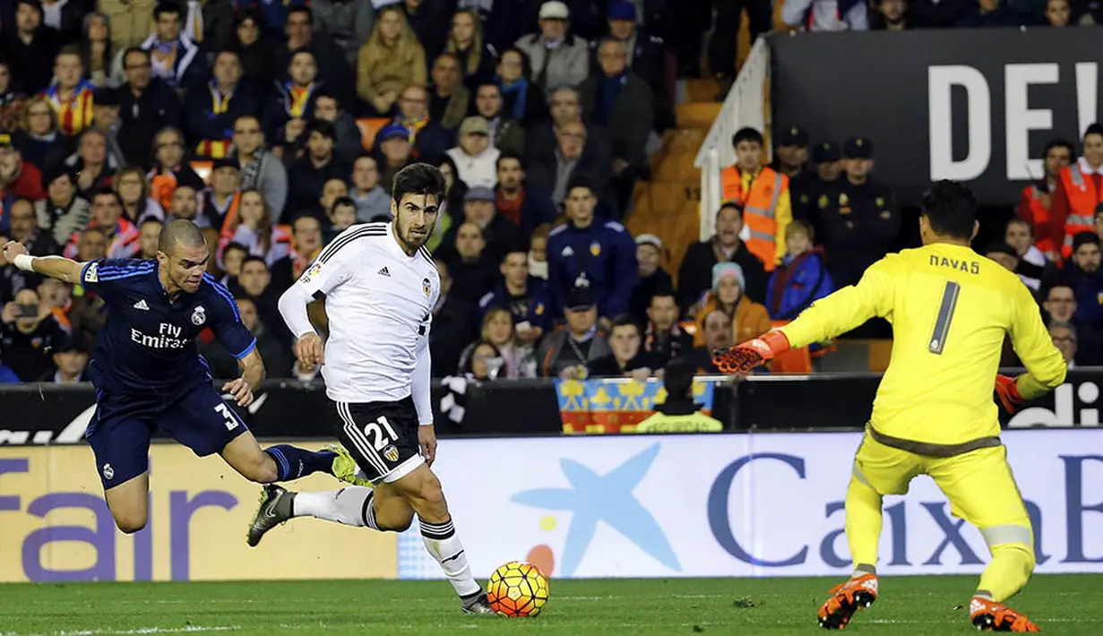 Gelandang Valencia, Andre Gomes, berhasil melewati hadangan bek Real Madrid, Pepe, pada laga La Liga Spanyol. Valencia kini berada pada posisi 10 klasemen sementara. (EPA/Juan Carlos Cardenas)