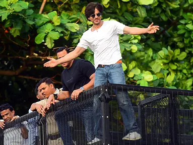 Shah Rukh Khan memberikan isyarat kepada para penggemar pada perayaan ulang tahunnya ke-54 dari balkon rumah King of Bollywood itu di Mumbai, Sabtu (2/11/2019). Seperti biasa, Shahrukh melakukan 'ritual' tahunan dengan menyapa para fans yang sudah berkumpul. (Sujit Jaiswal/AFP)