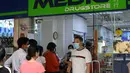 Warga mengantre di luar apotek untuk membeli masker, termometer, dan pembersih tangan di Singapura (29/1/2020). Singapura sejauh ini mengonfirmasi tujuh kasus virus corona - semuanya datang dari Wuhan. (AFP Photo/Roslan Rahman)