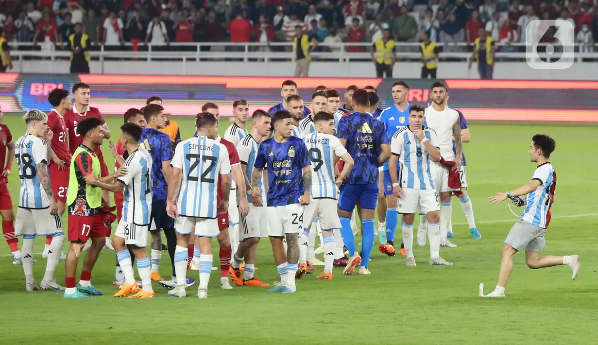 Seorang penyusup berlari ke tengah lapangan setelah laga FIFA Matchday antara Timnas Indonesia Vs Timnas Argentina di Stadion Utama Gelora Bung Karno (SUGBK), Senayan, Jakarta, Senin (19/6/2023). (Bola.com/Muhammad Iqbal Ichsan)