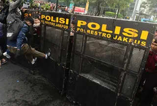 Salah satu pengunjuk rasa mencoba membuka blokade aparat keamanan saat berunjuk rasa di kawasan jalan Jenderal Sudirman, Jakarta, Jumat (12/6/2026). (merdeka.com/Arie Basuki)