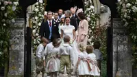 Pippa Middleton, adik Kate Middleton, dan James Matthews setelah mengikuti upacara pernikahan di Gereja St Mark, Englefield, Inggris, Sabtu (20/5). Adik ipar Pangeran William itu terlihat cantik mengenakan gaun karya Giles Deacon. (JUSTIN TALLIS/POOL/AFP)