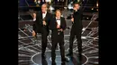 Roy Conli, Don Hall, dan Chris Williams, (kiri ke kanan) menerima piala Oscar untuk film animasi terbaik  dalam film "BIG HERO 6," di Academy Awards ke-87 di Dolby Theatre, Los Angeles, California, (22/2/2015). (Reuters/Mike Blake)