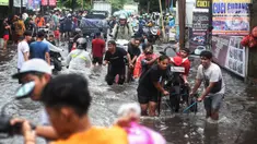 Sejumlah warga membawa motor di atas gerobak untuk melintasi banjir di kawasan Joglo, Jakarta, Jumat (22/3/2024). (Liputan6.com/Angga Yuniar)