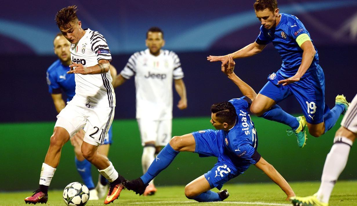 Pemain Dinamo Zagreb berusaha menghentikan laju pemain Juventus, Paulo Dybala, dalam laga kedua Grup H Liga Champions di Stadion Maksimir, Rabu (28/9/2016) dini hari WIB. (AFP)