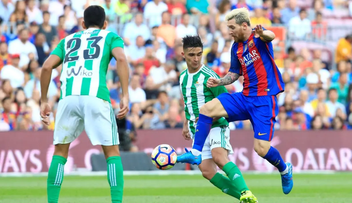 Pemain Barcelona, Lionel Messi, berusaha melewati hadangan pemain Real Betis dalam laga La Liga di Stadion Camp Nou, Minggu (21/8/2016) dini hari WIB. (AFP/Pau Barrena)