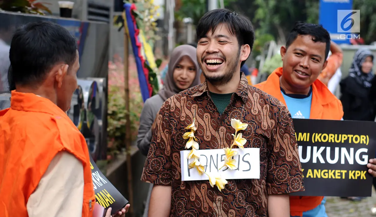 Aktivis memparodikan adegan peristiwa pertemuan anggota Pansus Hak Angket KPK dengan para narapidana kasus korupsi di depan Gedung KPK, Jakarta, Minggu (9/7). Mereka mengkritisi pertemuan tersebut. (Liputan6.com/Helmi Fithriansyah)