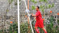 Achmad Kurniawan menghadapi tantangan berat dalam waktu singkat untuk jadi kiper utama Arema. (Bola.com/Iwan Setiawan)