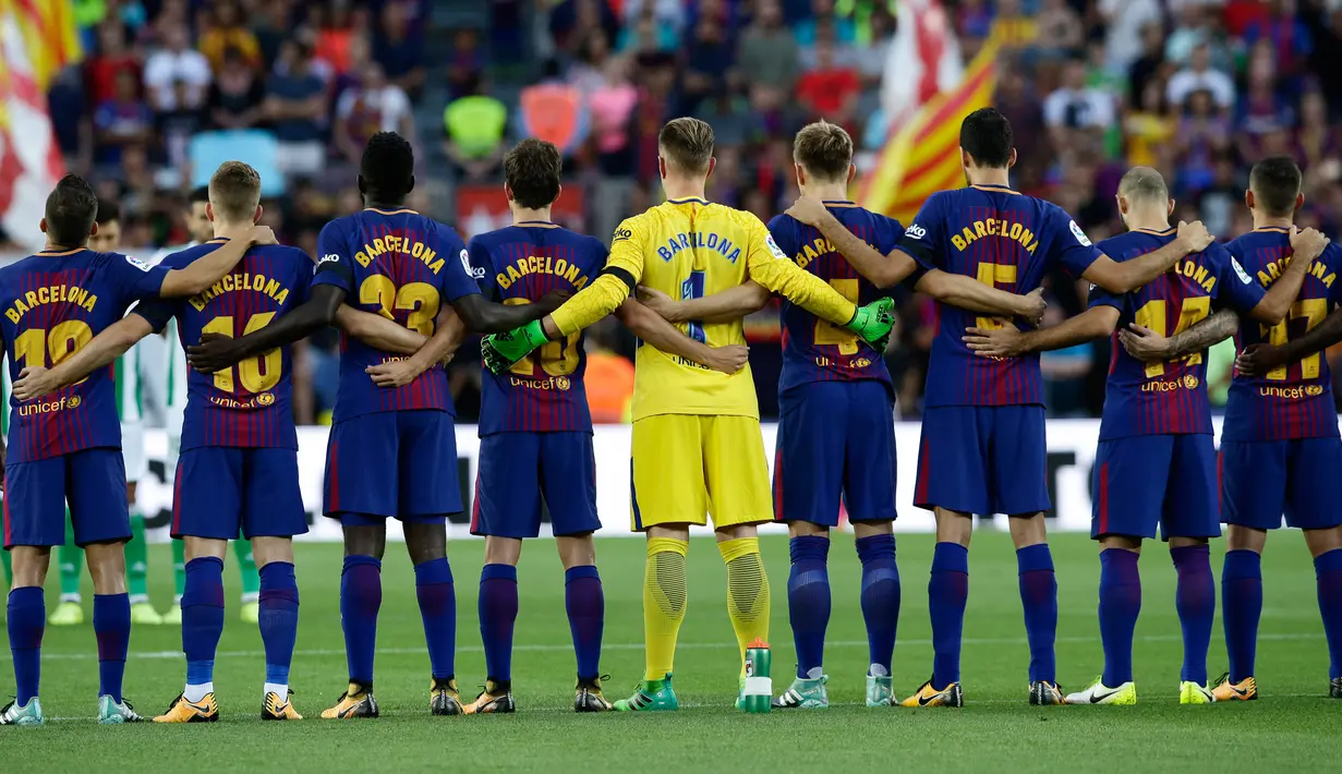 Pemain Barcelona mengheningkan cipta sebelum melakoni laga pekan pertama Liga Spanyol melawan Real Betis di Stadion Camp Nou, Minggu (20/8). Aksi tersebut sebagai bentuk duka cita atas serangan teror di pusat Kota Barcelona. (AP Photo/Manu Fernandez)