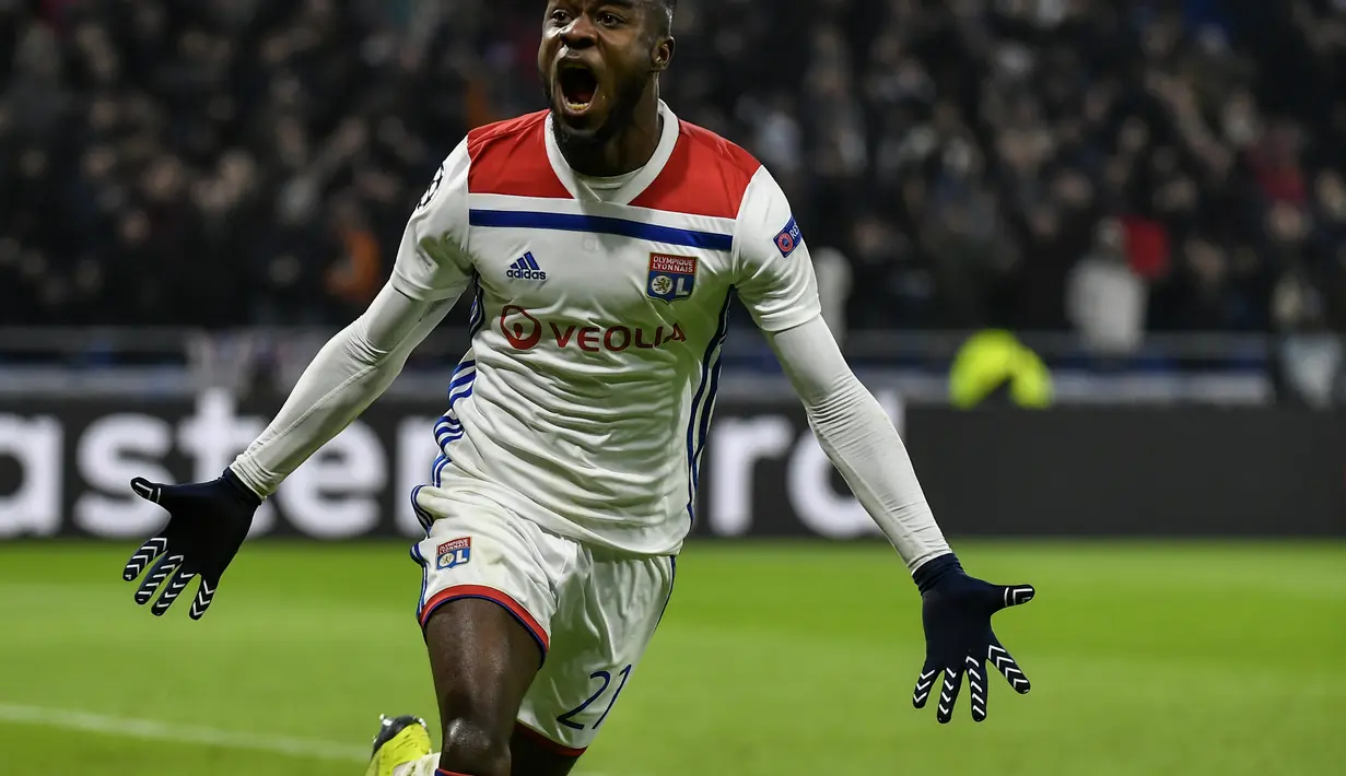 Maxwel Cornet tampil apik usai mencetak dua gol ke gawang Manchester City pada laga lanjutan liga champions yang berlangsung di stadion Parc Olympique Lyonnais, Prancis, Rabu (28/11). Lyon bermain imbang 1-1 kontra Manchester City. (AFP/Jeff Pachoud)