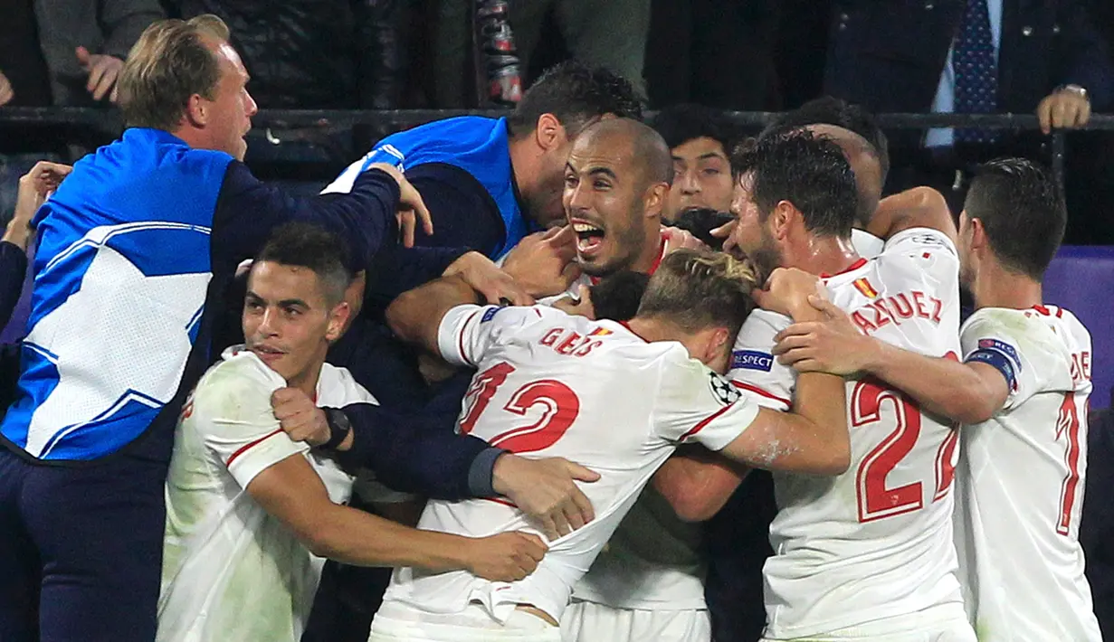 Pemain Sevilla merayakan gol rekan setimnya, Guido Pizarro (tengah) pada laga kelima Grup E Liga Champions kontra Liverpool di Stadion Ramon Sanchez Pizjuan, Rabu (22/11). Liverpool dan Sevilla bermain imbang 3-3. (AP/Miguel Morenatti)