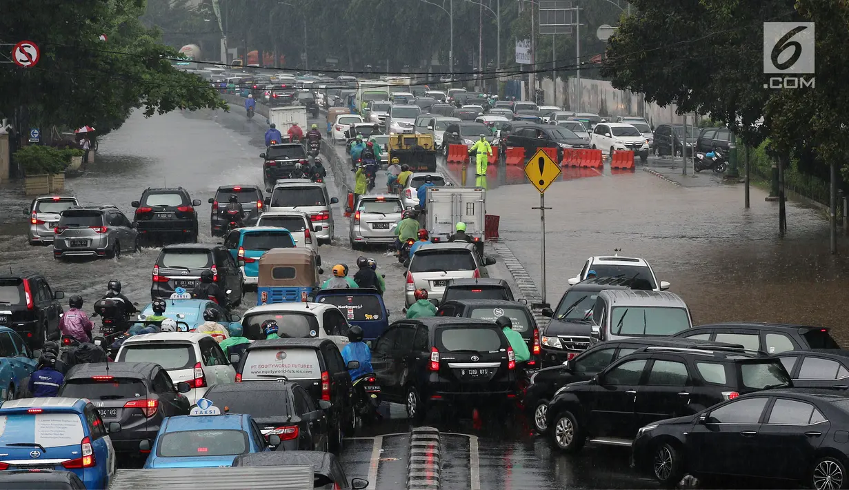 Jalan Medan Merdeka Timur menuju Stasiun Gambir ditutup Akibat genangan dengan tinggi sekitar 20 cm,  Jakarta, Kamis (15/2). Akibat pentuupan jalan itu pengendara harus memutar dulu lewat Jalan Medan Merdeka Selatan. (Liputan6.com/Johan Tallo)
