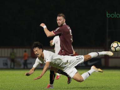 Pemain Persija Jakarta, Marko Simic (belakang) berebut bola dengan pemain Korea Selatan U-23, Lee Eun-beom pada laga uji coba di Stadion PTIK, Jakarta, (21/6/2018). Persija kalah 1-3. (Bola.com/ Nick Hanoatubun)