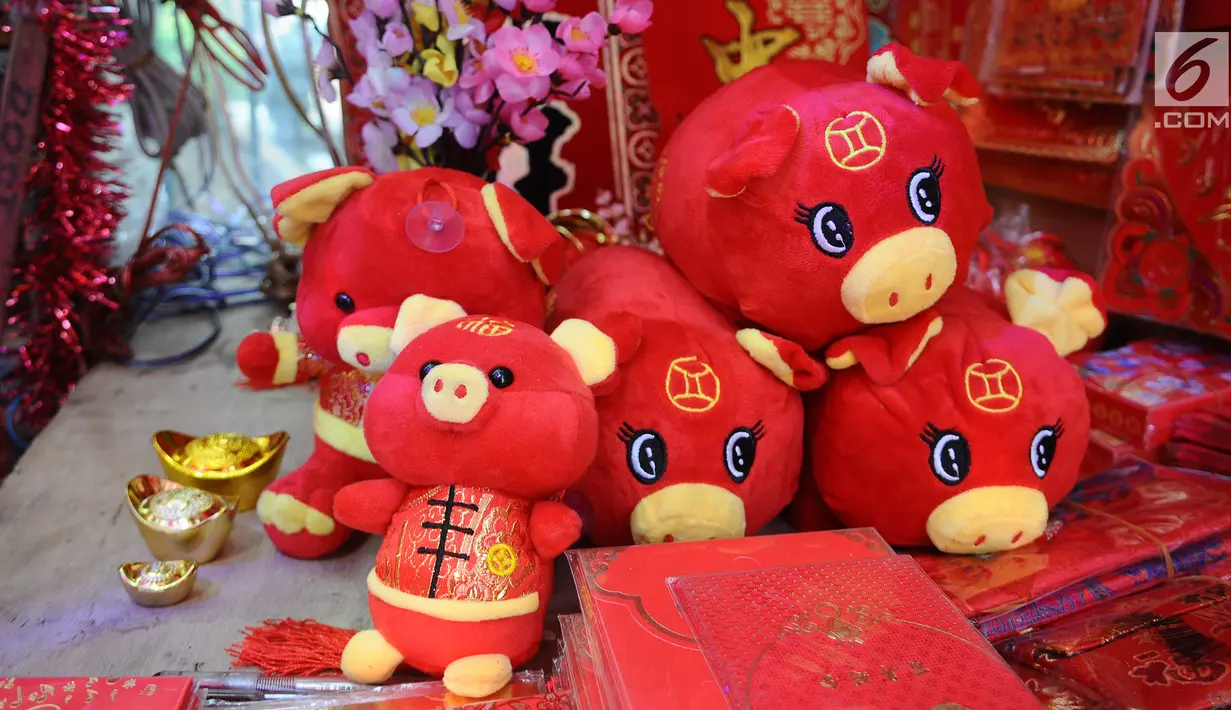 Boneka bertema Imlek dijual di kawasan Glodok, Jakarta, Kamis (31/1). Pernak-pernik Imlek bershio babi tanah sudah mulai ramai dijual. (Liputan6.com/Herman Zakharia)
