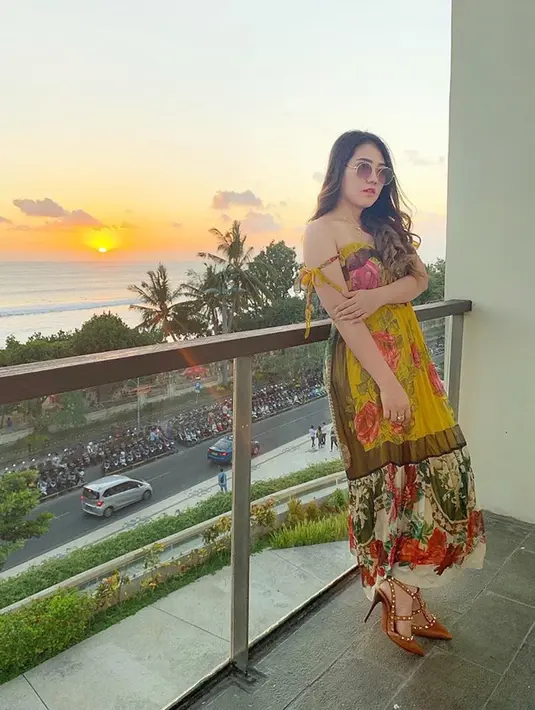 Gaya Via Vallen saat berfoto bersama matahari terbenam pun enggak kalah memesona. Pasalnya, Via mengenakan dress bernuansa kuning yang tampak kompak dengan rona sinar sunset. Selain itu, Via juga mengenakan kacamata dan high heels yang membuat penampilannya semakin modis.(Liputan6.com/IG/viavallen)